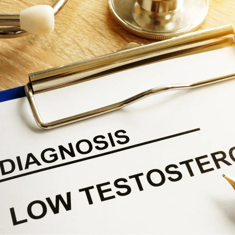 Clipboard reading Diagnosis Low Testosterone beside a stethoscope and pen on a desk
