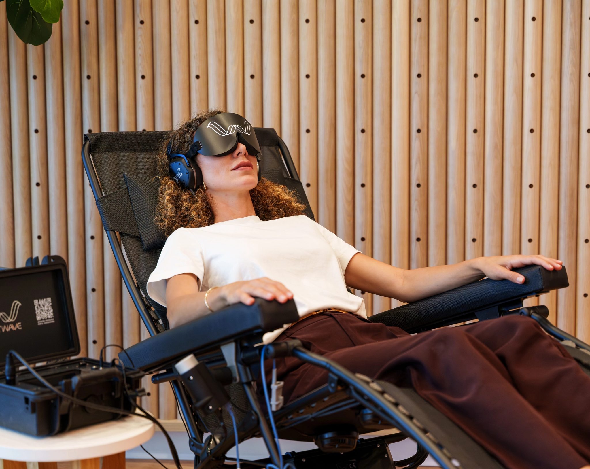 A member reclined in the Shiftwave therapy chair