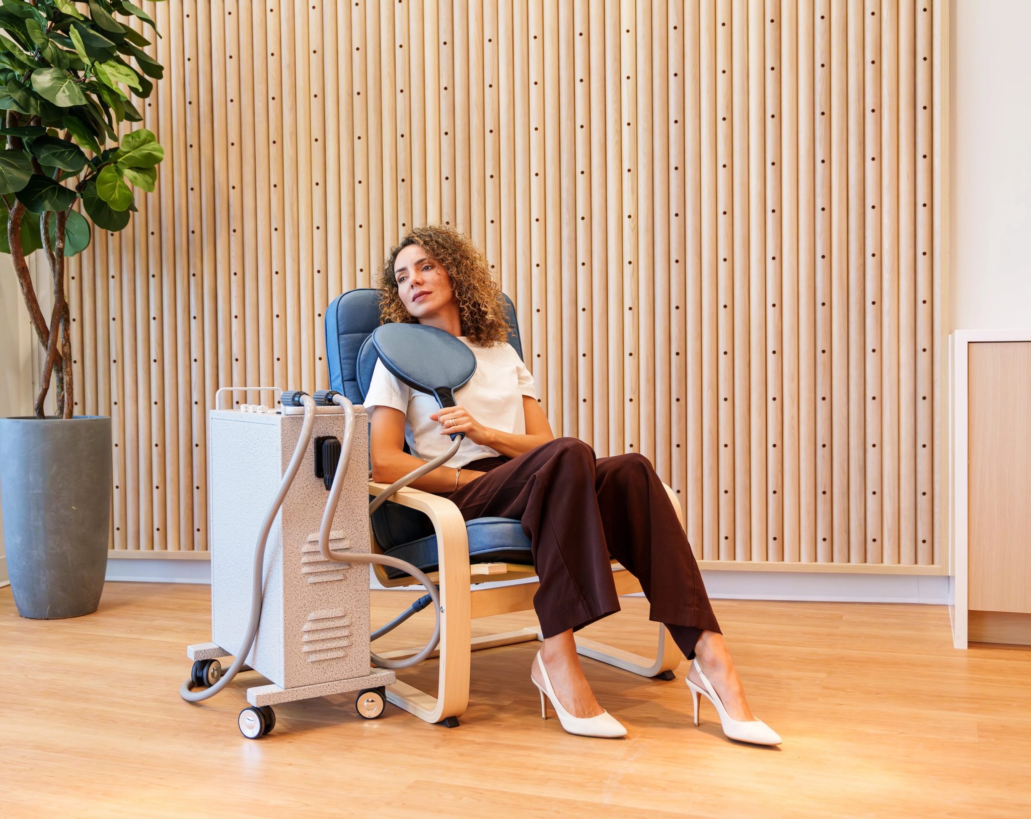 A man receiving PEMF therapy in a clinic chair
