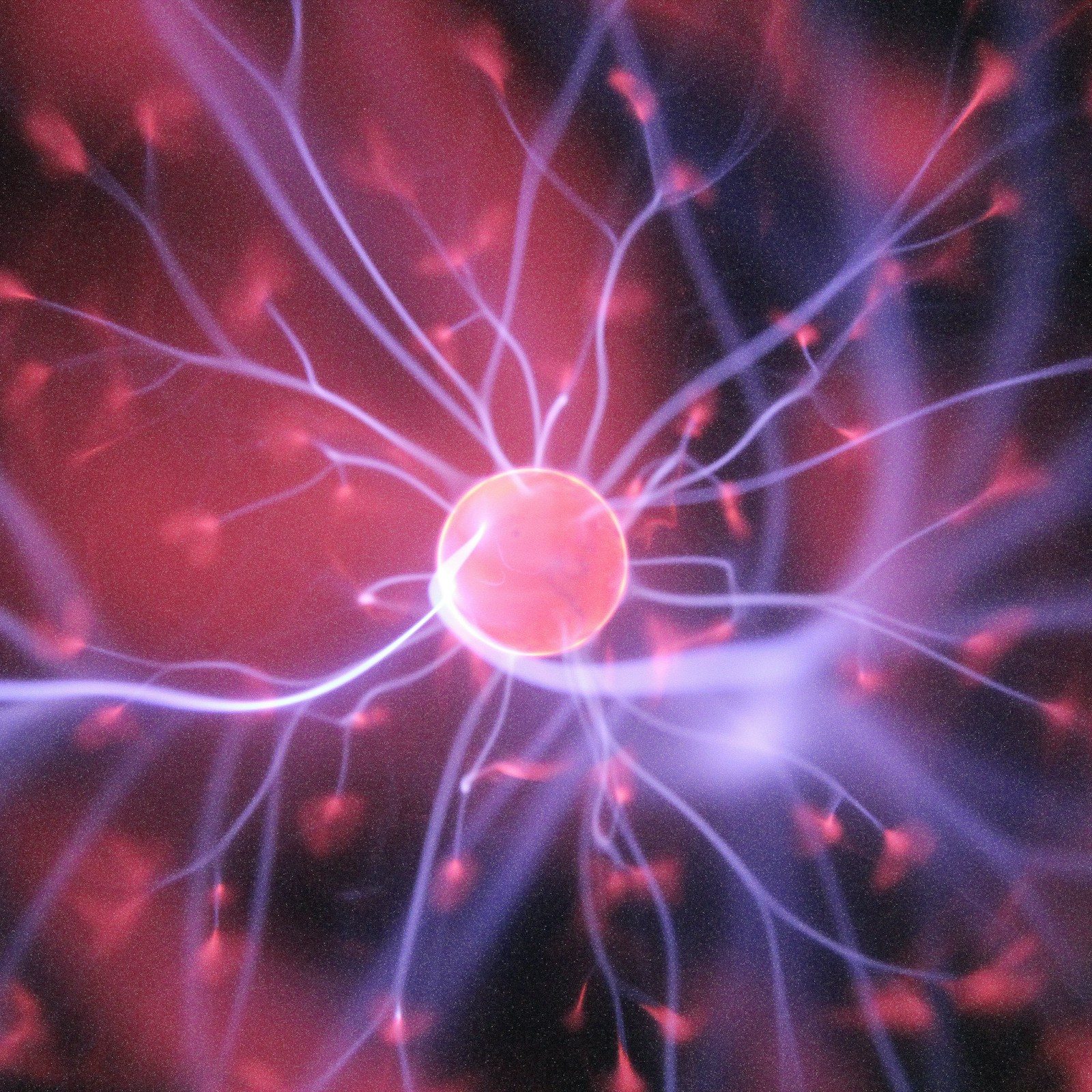 Red plasma sphere with branching electric filaments